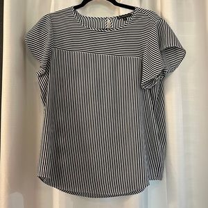 Adrianna Papell navy with white stripes shirt with short flowy sleeves.